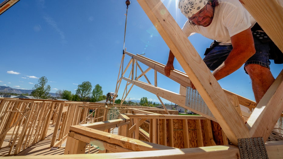 construction workers build the roof of the house