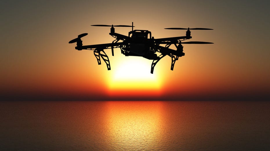 3D drone flying above a sunset sea