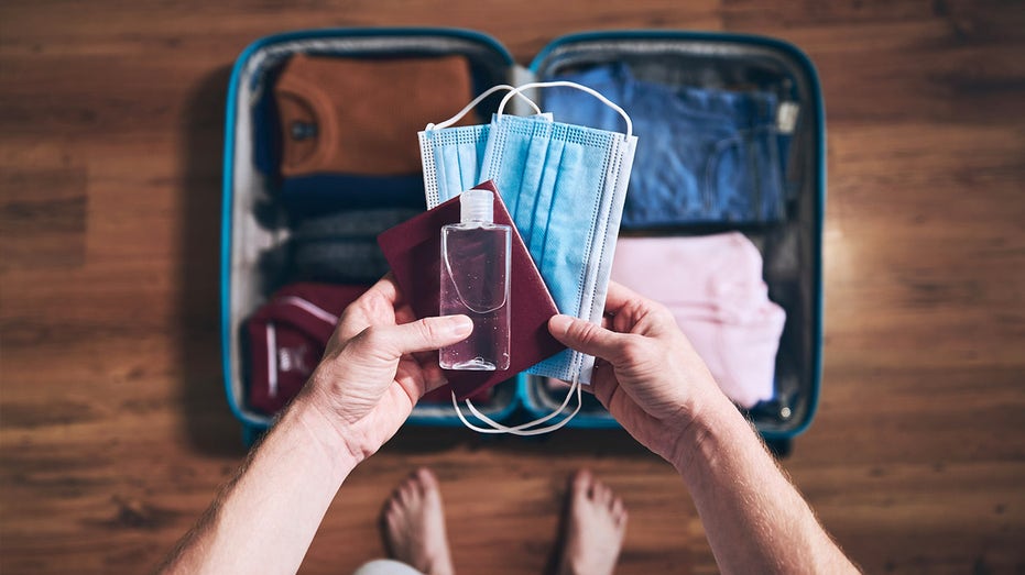 Traveler packs mask and hand sanitizer