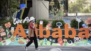 A person walks past a sign at the Alibaba Group Holding Ltd. headquarters in Hangzhou, China, on Saturday, May 8, 2021. Alibaba is scheduled to report fourth-quarter results on May 13. - Fox Business News