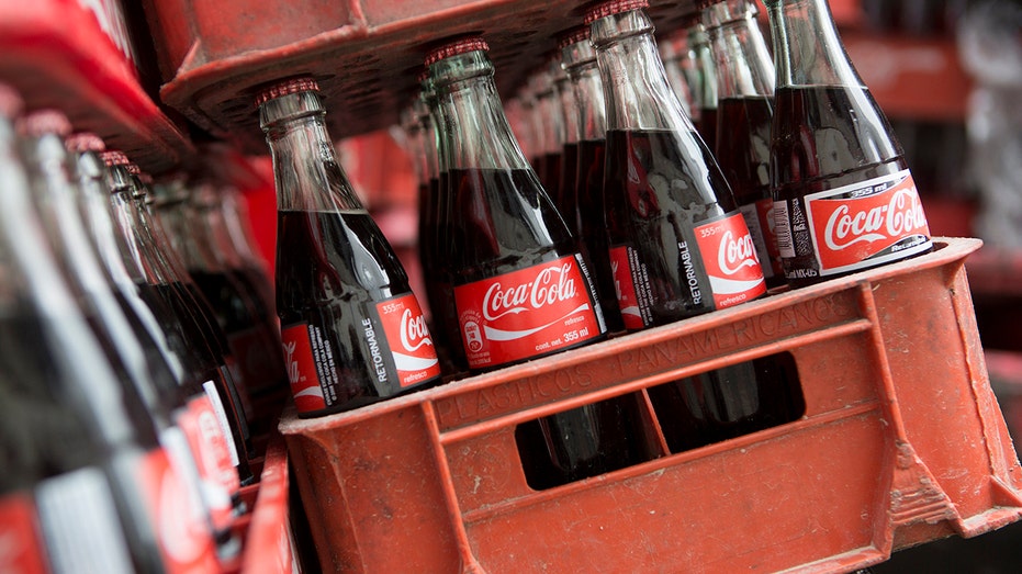 Coca-Cola bottles sit in a delivery truck