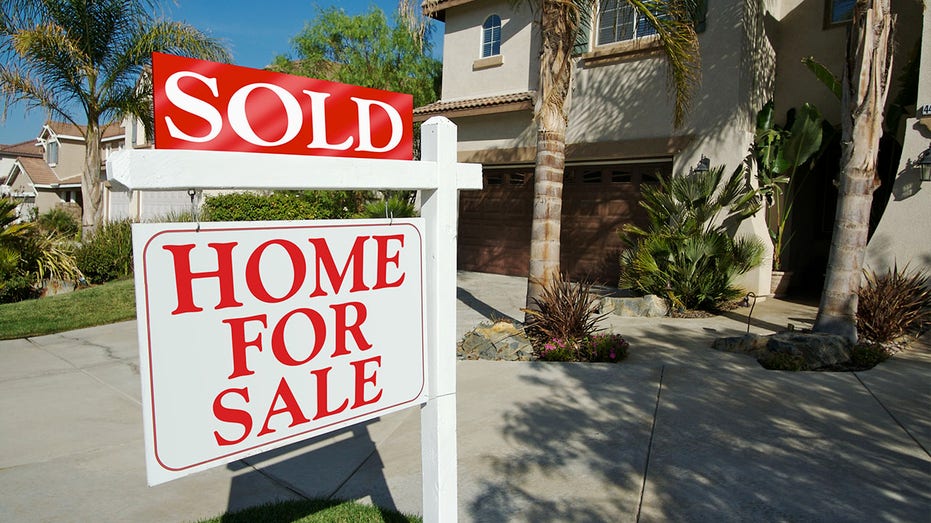 Sold Home For Sale Sign and New House