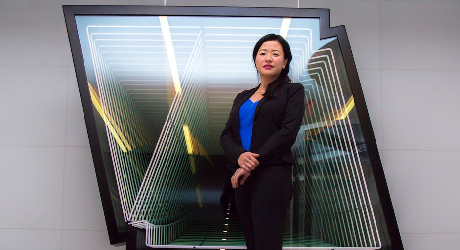 Silverstein Properties Vice President of Design Michiko Ashida poses in front of 4 World Trade Center art.