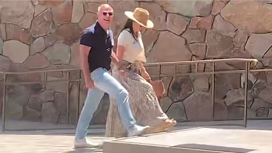 Jeff Bezos and Lauren Sanchez holding hands