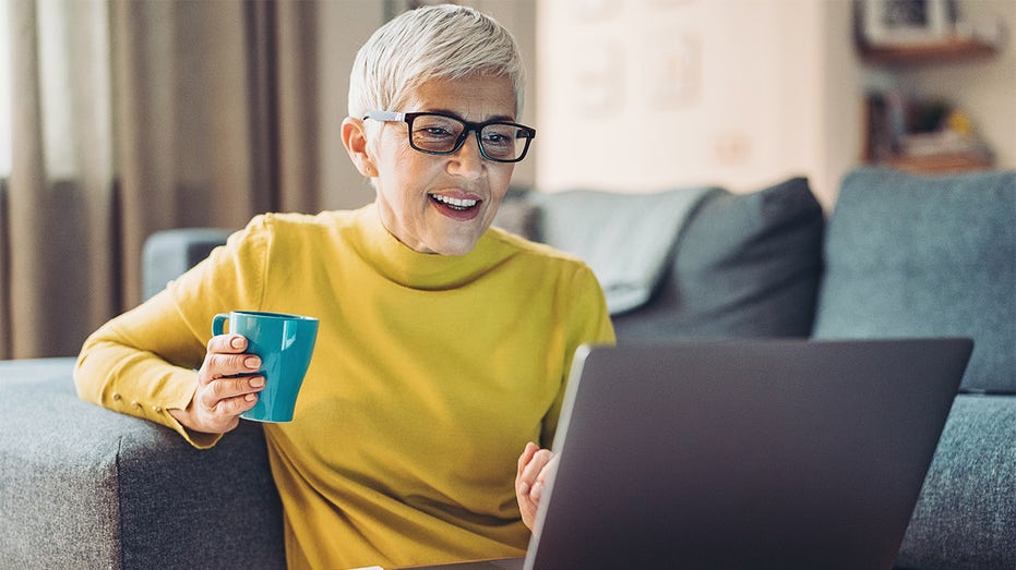 woman on laptop smiling