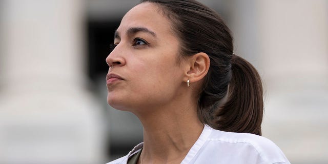 Rep. Alexandria Ocasio-Cortez (D-NY) talks with a reporter.