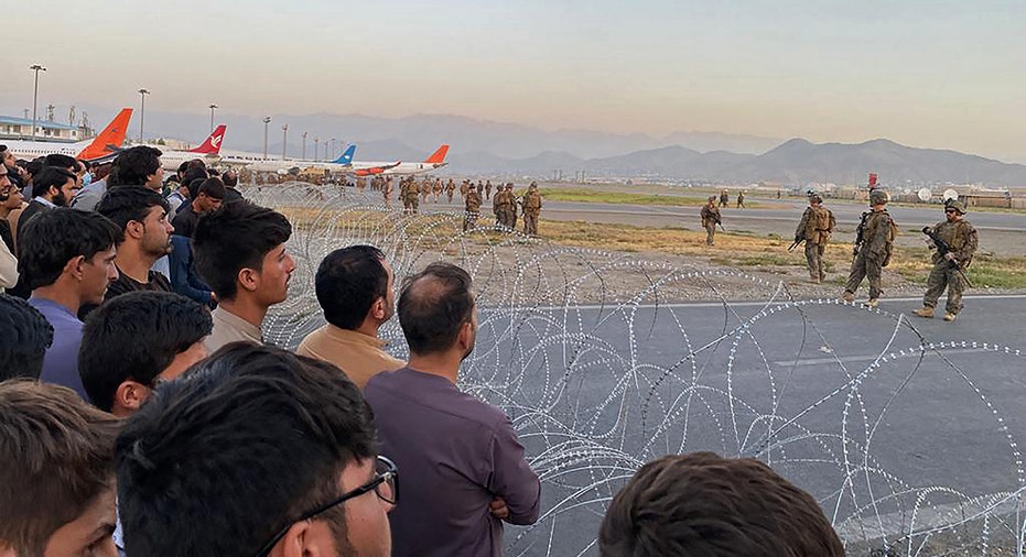 Afghan refugees wait to board airplane