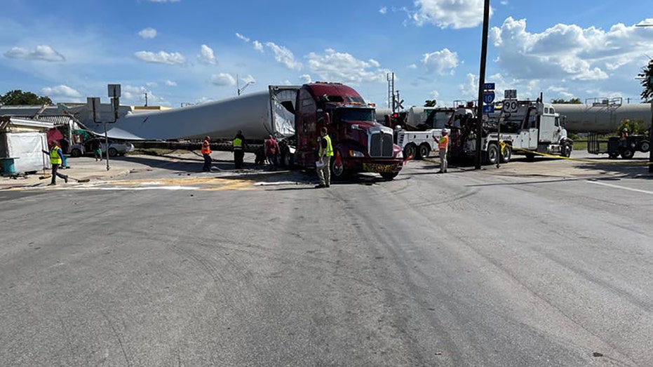 A freight train barreled through a semi-truck that was carrying what appeared to be a piece of a wind turbine as the 18-wheeler drove over the tracks at a rail crossing in Texas on Sunday.