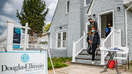 West Hempstead, N.Y.: Real estate agent Rosa Arrigo stands in the doorway as Giovani and Nicole Quiroz of Brooklyn, New York visit an open house in West Hempstead, New York on April 18, 2021. (Photo by Raychel Brightman/Newsday RM via Getty Images)