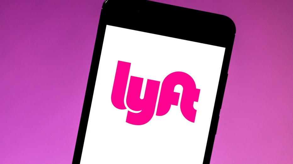 The Lyft logo in a smartphone illustration