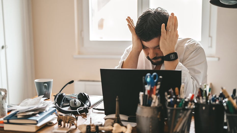 Employee stressed at his desk