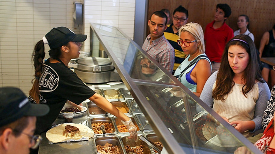 Chipotle employee serves customers
