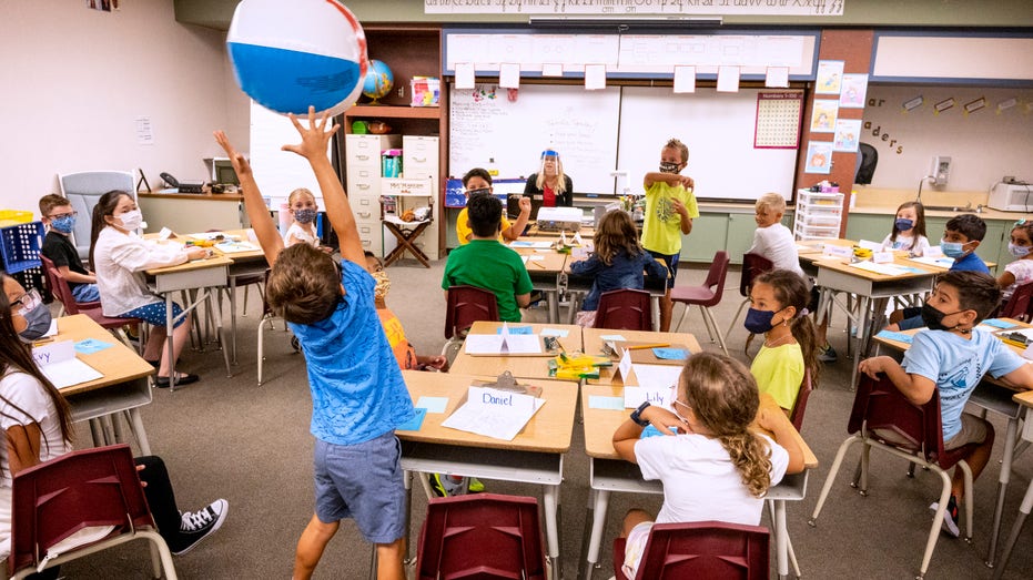 Kids playing with a beachball in class