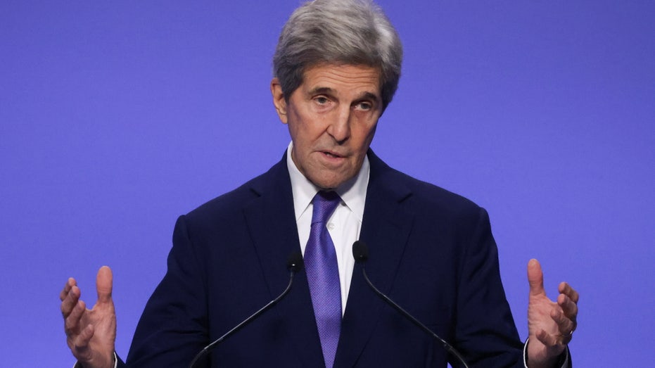 Climate Change envoy John Kerry speaks in a suit at climate change conference