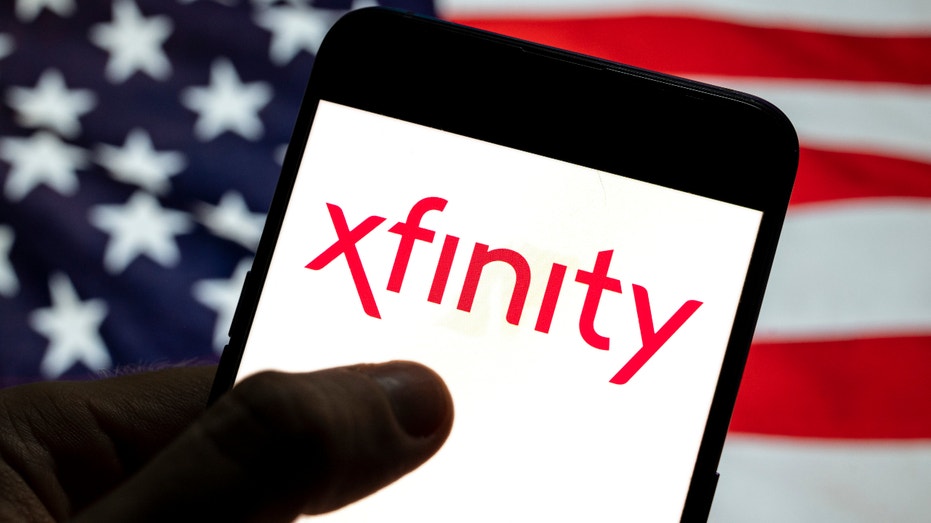 Comcast, Xfinity, logo is seen on an Android mobile device with United States of America (USA). (Photo Illustration by Budrul Chukrut/SOPA Images/LightRocket via Getty Images)