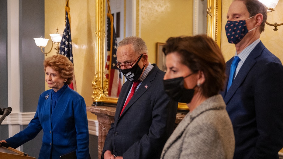 Sen. Debbie Stabenow, a Democrat from Michigan, from left, speaks with Senate Majority Leader Chuck Schumer, a Democrat from New York, Sen. Ron Wyden, a Democrat from Oregon, and Gina Raimondo, the U.S. Secretary of Commerce, during a press conference on the Covid-19 pandemic impact on the supply chain at the US Capitol in Washington, DC, US, Thursday, November 4, 2021. House Democrats appear to be closing in on votes as early as today on the White House's $1.75 billion tax and spending plan and its accompanying bipartisan infrastructure plan, although negotiations continue between the caucuses of both chambers. Photographer: Craig Hudson/Bloomberg