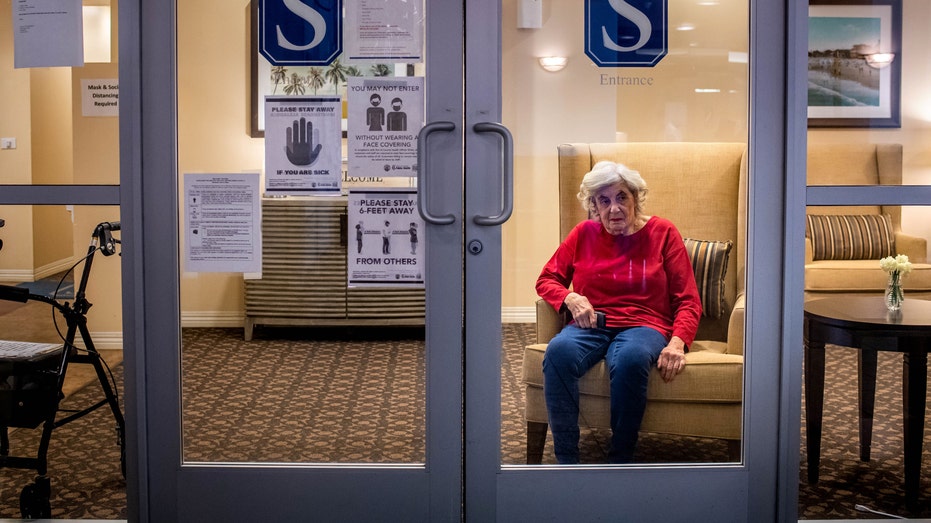 Cynthia Tachner, 86, waits to visit through glass with her daughter Karen Klink, of Hermosa Beach, at Silverado Beach Cities Memory Care in Redondo Beach on Monday, March 8, 2021.