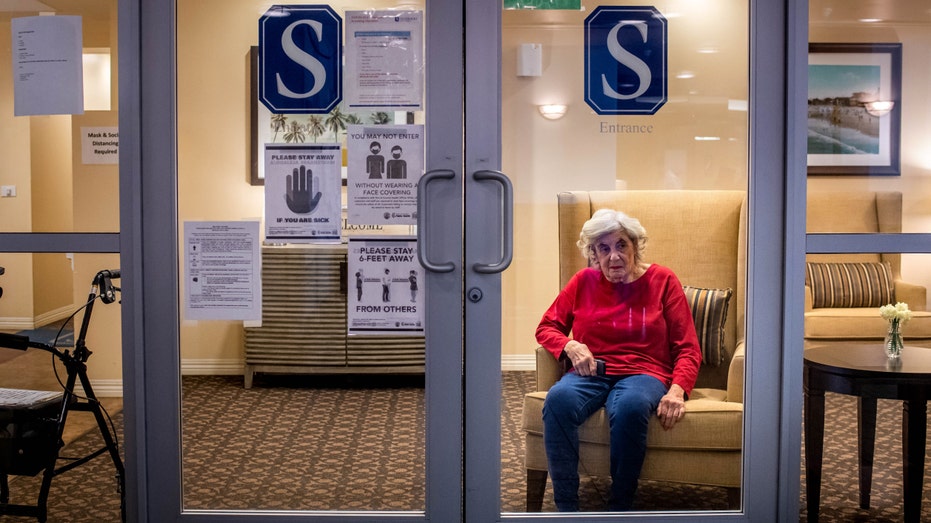 Cynthia Tachner, 86, waits to visit through glass with her daughter Karen Klink, of Hermosa Beach, at Silverado Beach Cities Memory Care in Redondo Beach on Monday, March 8, 2021.