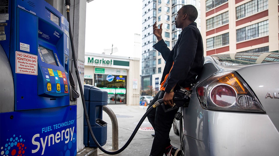 A man fuels a car at a gas station in New York on Oct. 13, 2021. 