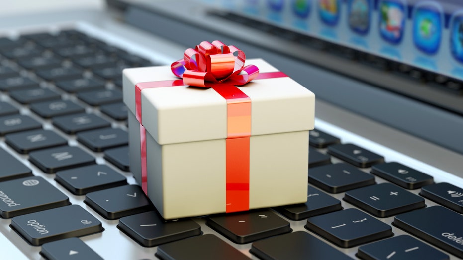 White gift box with red ribbon on keyboard