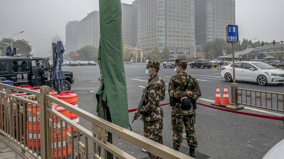 Soldiers and police stand guard near Tiananmen Square in Beijing, China, on Friday, Nov. 5, 2021. 