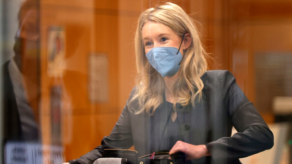Theranos founder and former CEO Elizabeth Holmes goes through a security checkpoint as she arrives for her trial at the Robert F. Peckham Federal Building on Nov. 17, 2021, in San Jose, California.