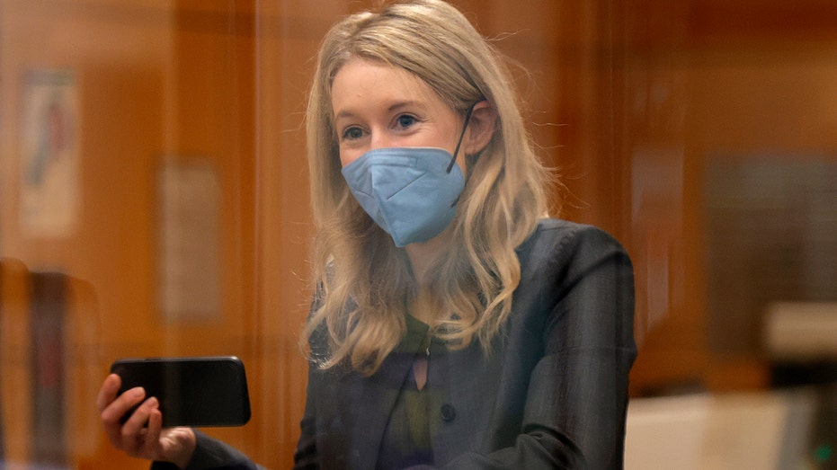 Theranos founder and former CEO Elizabeth Holmes goes through a security checkpoint as she arrives for her trial at the Robert F. Peckham Federal Building on Nov. 17, 2021, in San Jose, California. 