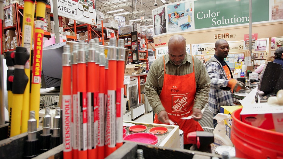 Ralph Polk (left) and Fred James work in the paint department at a Home Depot store Feb. 21, 2006, in Chicago, Illinois. 