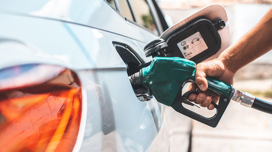 Detail of hand filling the fuel tank