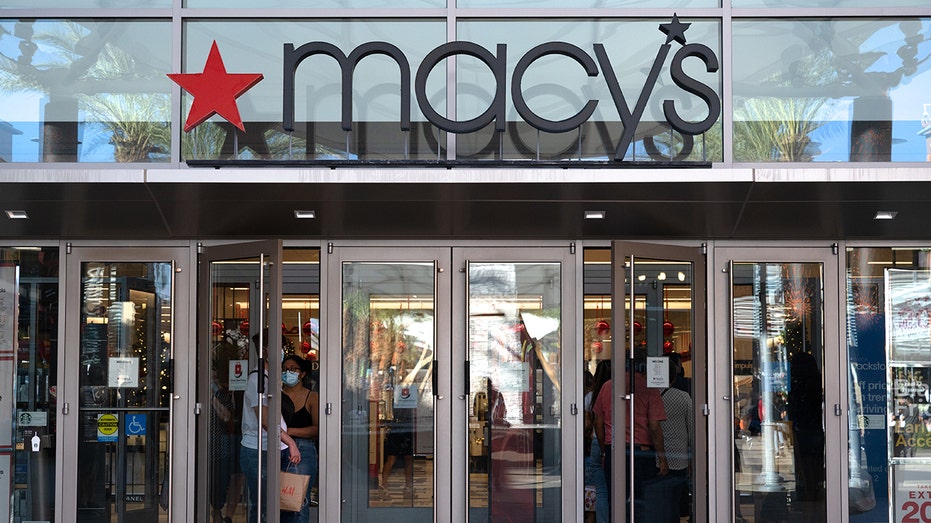 Shoppers exit a Macy's department store 