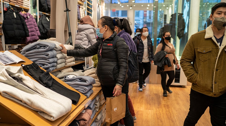 Shoppers search for clothing at Uniqlo Retail Clothing Company Nov. 12, 2021, in New York City. 