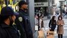 San Francisco Police officers stand guard outside of the Nike store while shoppers search for Black Friday deals at Union Square in San Francisco, Calif. Friday, Nov. 26, 2021. (Jessica Christian/The San Francisco Chronicle via Getty Images)