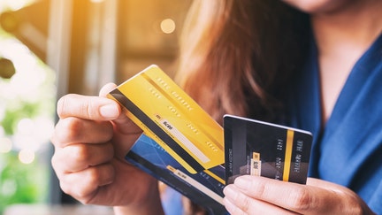 A woman holding credit cards.
