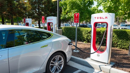 Tesla automobile plugged in and charging a Supercharger rapid battery charging station for the electric vehicle company Tesla Motors, in the Silicon Valley town of Mountain View, California, August 24, 2016.