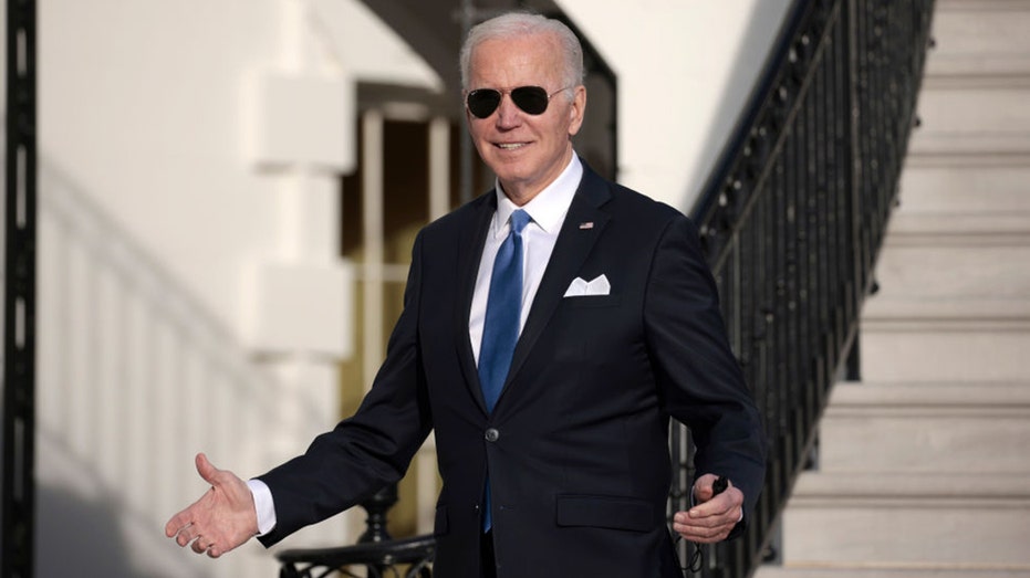 President Biden gestures to journalists after returning to the White House on Dec. 2, 2021, in Washington, D.C. 