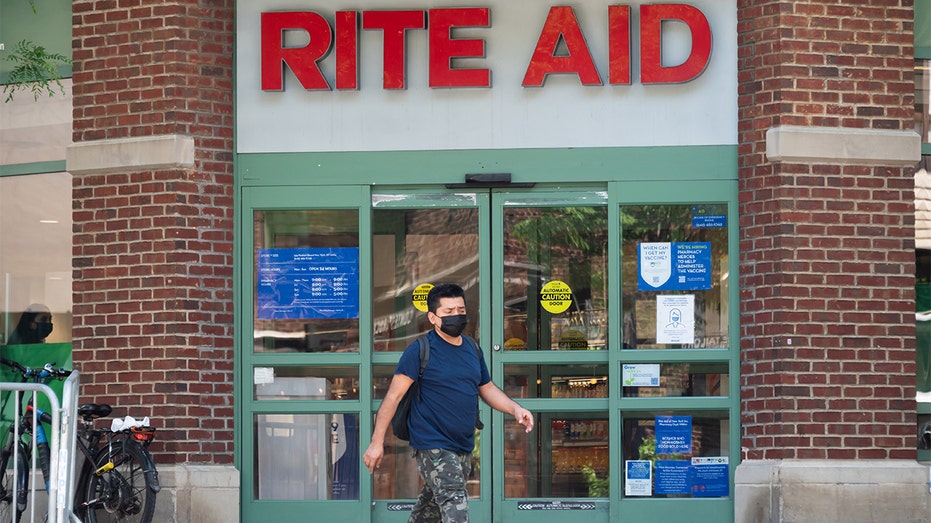 A person walks outside a Rite Aid pharmacy on May 27, 2021, in New York City. 