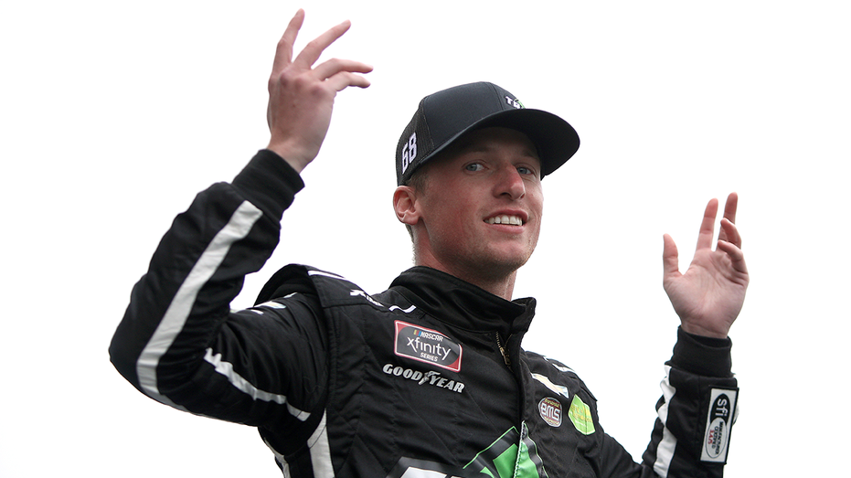 KANSAS CITY, KANSAS - OCTOBER 23: Brandon Brown, driver of the #68 TradeTheChain.com Chevrolet, waves to fans during pre-race ceremonies prior to the NASCAR Xfinity Series Kansas Lottery 300 at Kansas Speedway on October 23, 2021 in Kansas City, Kansas. (Photo by Sean Gardner/Getty Images)