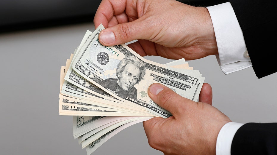 Businessman holding dollar bills in his hands on July 02, 2014, in Berlin, Germany.