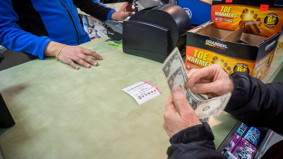 A woman buys a chance to win the $1.5 billion Powerball jackpot on Wednesday, Jan. 13, 2016. 