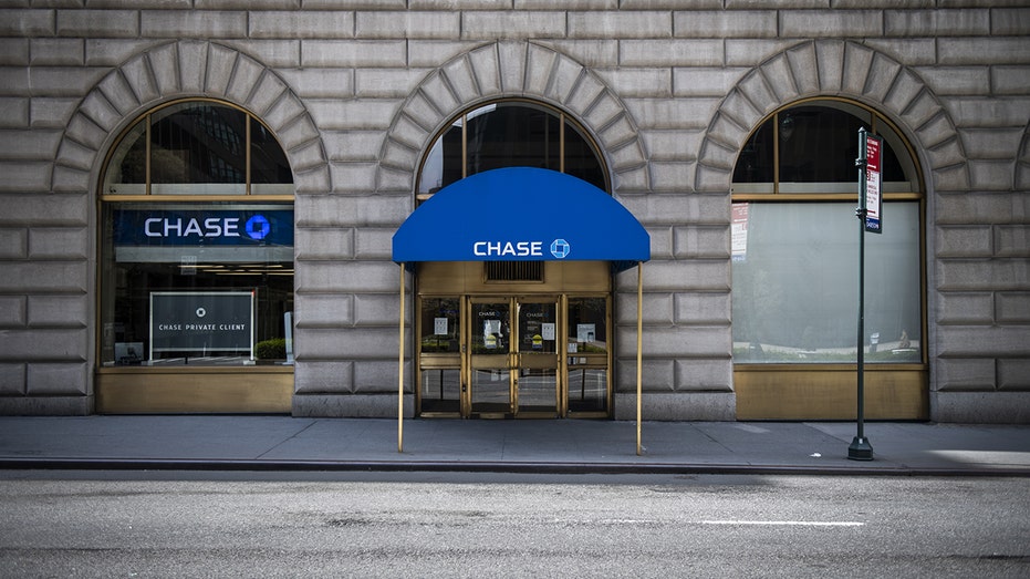 An empty sidewalk front of a temporarily closed JPMorgan Chase & Co. bank branch in New York on Friday, April 10, 2020. 