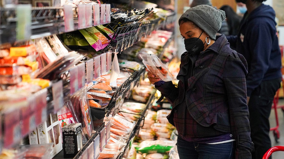 People select fish products at a grocery store in New York City