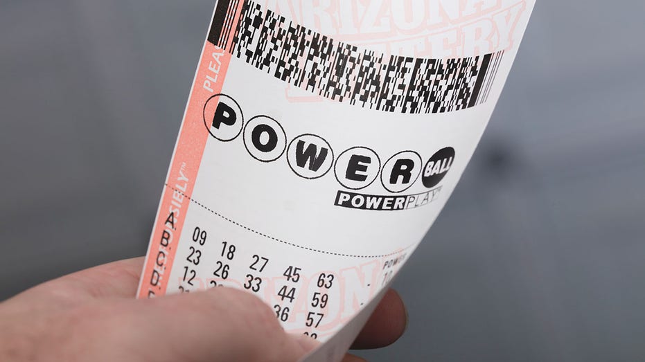 Powerball ticket in person's hand