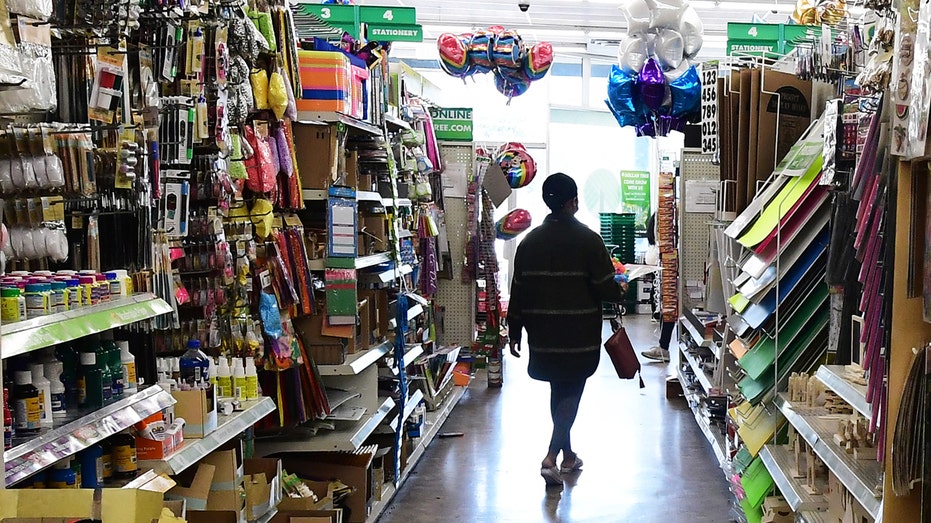 A shopper walks through the aisles of the Dollar Tree store in Alhambra, California, on Dec. 10, 2021.