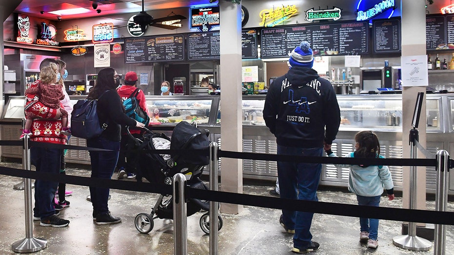 People wait in line to order at Philippe's, a downtown Los Angeles restaurant in business since 1908 famed for its French Dipped Sandwich, in Los Angeles, California, on Dec. 10, 2021. 