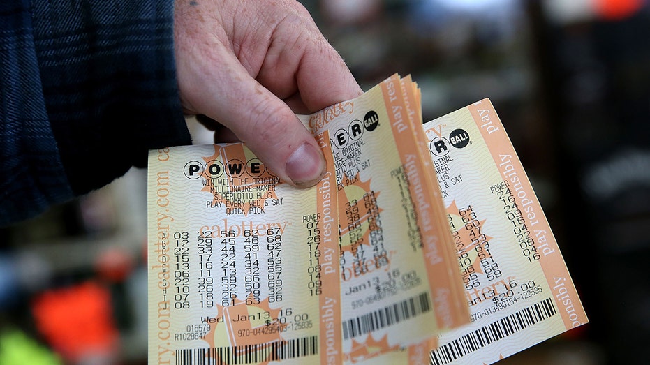 A customer holds a handful of Powerball tickets at Kavanagh Liquors on Jan. 13, 2016, in San Lorenzo, California.