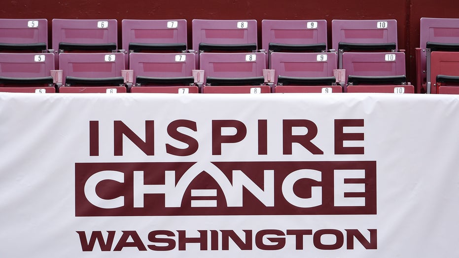 An Inspire Change banner is seen before an NFL football game between the Los Angeles Rams and Washington Football Team at FedExField