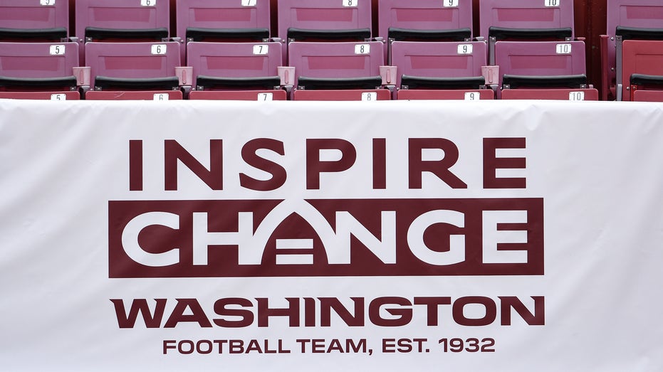 An Inspire Change banner is seen before an NFL football game between the Los Angeles Rams and Washington Football Team at FedExField