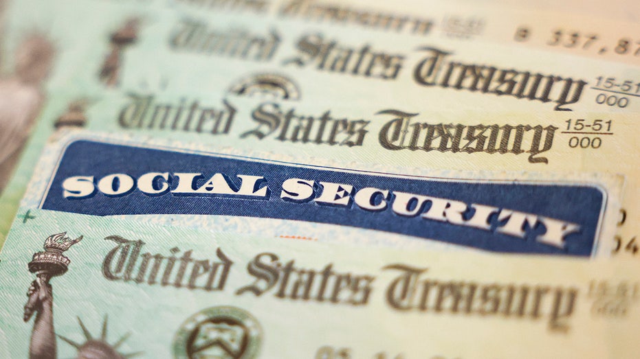 In this photo illustration, a Social Security card sits alongside checks from the U.S. Treasury on Oct. 14, 2021, in Washington, D.C.