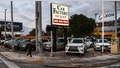 A pedestrian walks past a pre-owned car sales lot in Miami, Florida on January 12, 2022. - The seven percent increase in the Labor Department's consumer price index (CPI) over the 12 months to December was the highest since June 1982, as prices rose for an array of goods especially housing, cars and food. (Photo by CHANDAN KHANNA / AFP) (Photo by CHANDAN KHANNA/AFP via Getty Images)