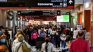 People are seen at the Miami International Airport in Miami, Florida on January 3, 2022. - After a bruising holiday week of flight cancellations and record surges in Covid-19 cases, a powerful winter storm Monday further snarled US transport and shuttered the federal government and schools. (Photo by CHANDAN KHANNA / AFP) (Photo by CHANDAN KHANNA/AFP via Getty Images)